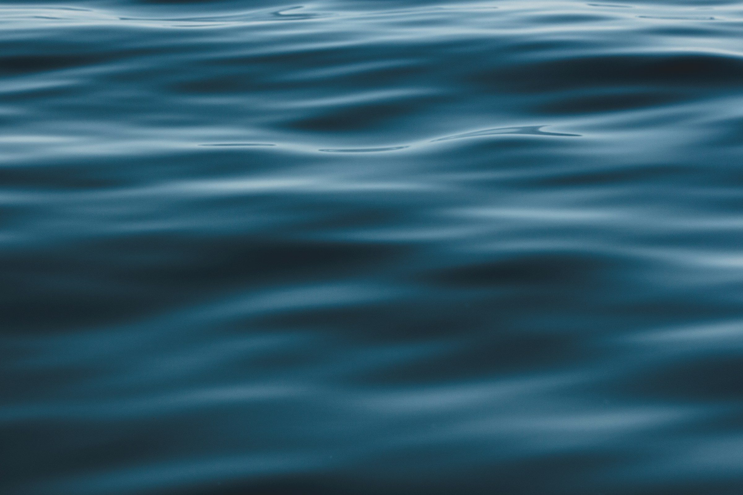 Close, rippled surface of dark blue water